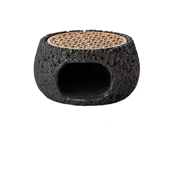 Top view of black cement incense burner featuring textured volcanic surface and rosewood grate for burning crystal or herbal incense
