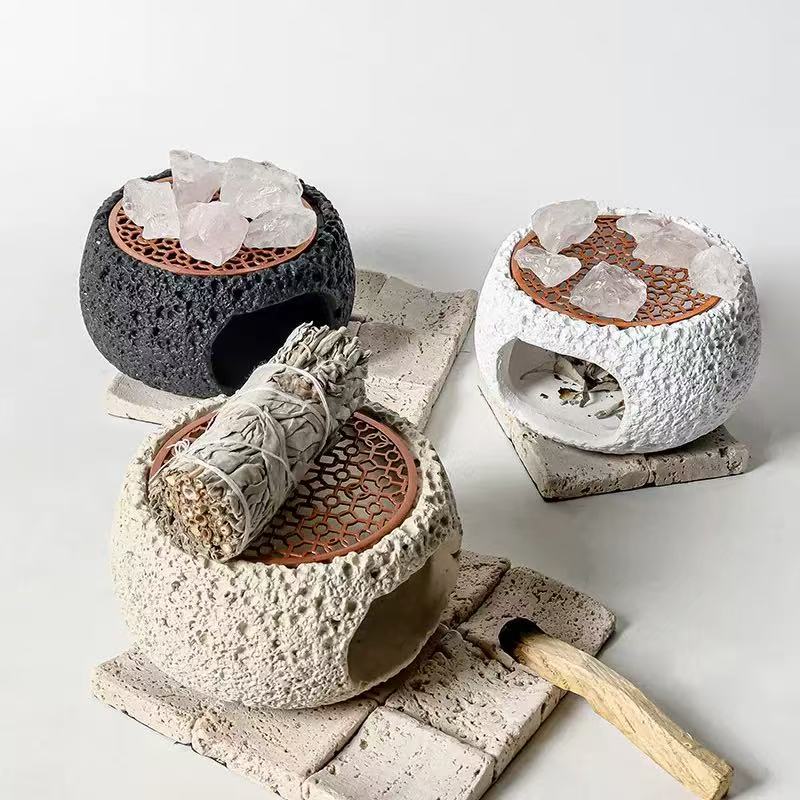 Set of handmade cement crystal incense burners in black, white, and off-white, featuring rosewood grates, raw quartz crystals, palo santo stick, and a white sage smudge bundle for energy cleansing rituals