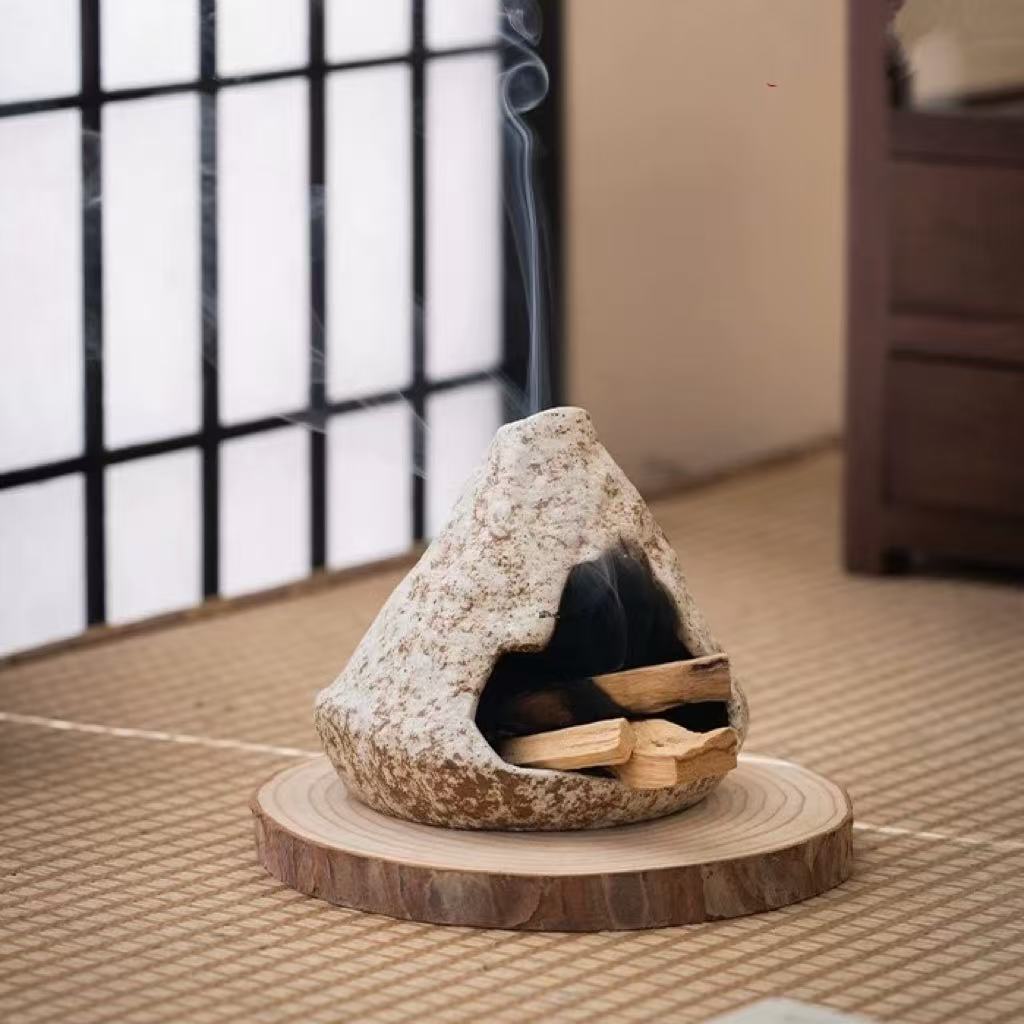 Handmade ceramic incense burner placed on a pine wood tray with visible incense smoke curling upward in a traditional tatami room setting