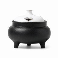 Classic black and white ceramic electric incense burner with a lidded three-leg design for flameless incense heating and home fragrance.