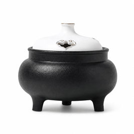 Classic black and white ceramic electric incense burner with a lidded three-leg design for flameless incense heating and home fragrance.
