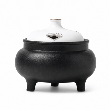 Classic black and white ceramic electric incense burner with a lidded three-leg design for flameless incense heating and home fragrance.