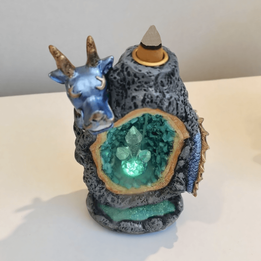 Top-down view of battery-powered dragon backflow incense burner with glowing crystal chamber and incense cone on top.