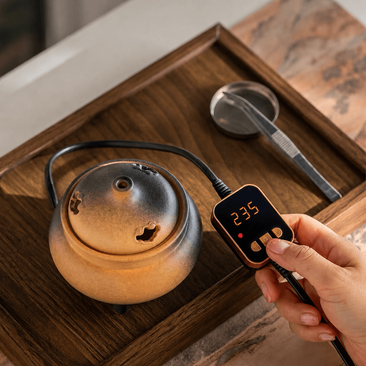Ceramic electric incense burner with handheld controller set to 235°C, showing precise temperature adjustment for flameless incense heating.
