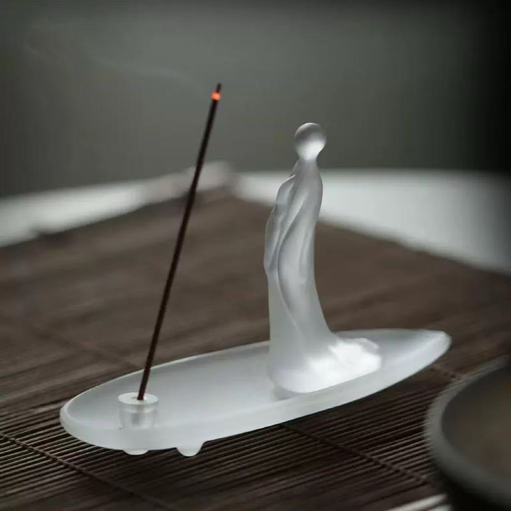 Frosted glass incense holder on table
