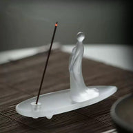 Frosted glass incense holder on table