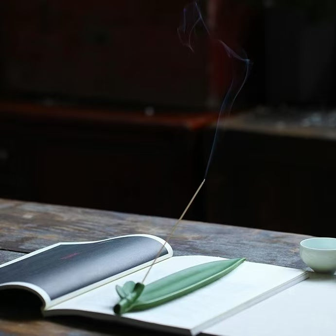 Green leaf ceramic incense holder with book and tea