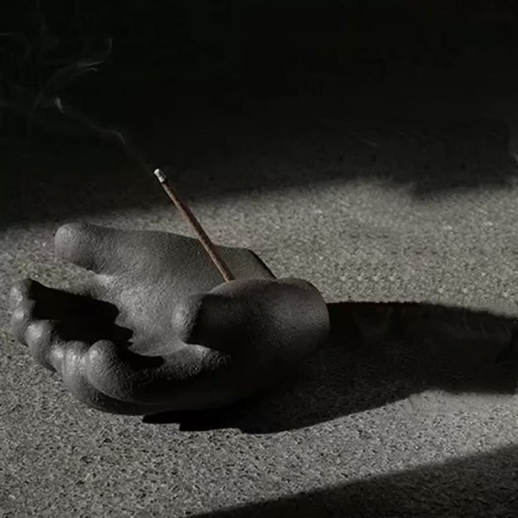 Hand incense holder shadow