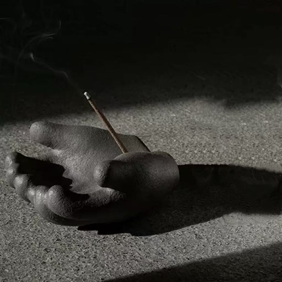 Hand incense holder shadow
