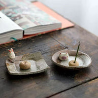Handmade ceramic incense holder featuring rabbit and pig figurines, artisanal incense burner for home decor, yoga, and meditation.
