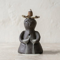 Handmade ceramic backflow incense burner statue with a flower crown and soft smoke waterfall effect.