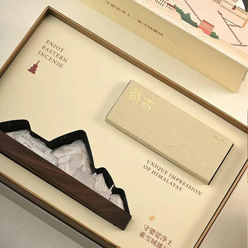Close-up of incense burner gift set featuring mountain-shaped holder and Tibetan incense packaging