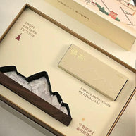 Close-up of incense burner gift set featuring mountain-shaped holder and Tibetan incense packaging