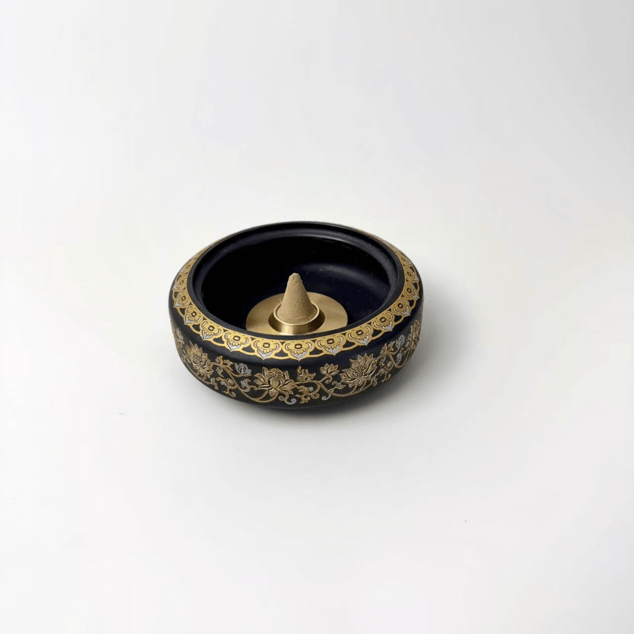 How to use incense cone: demonstration of incense cone placed inside antique black and gold cloisonné burner