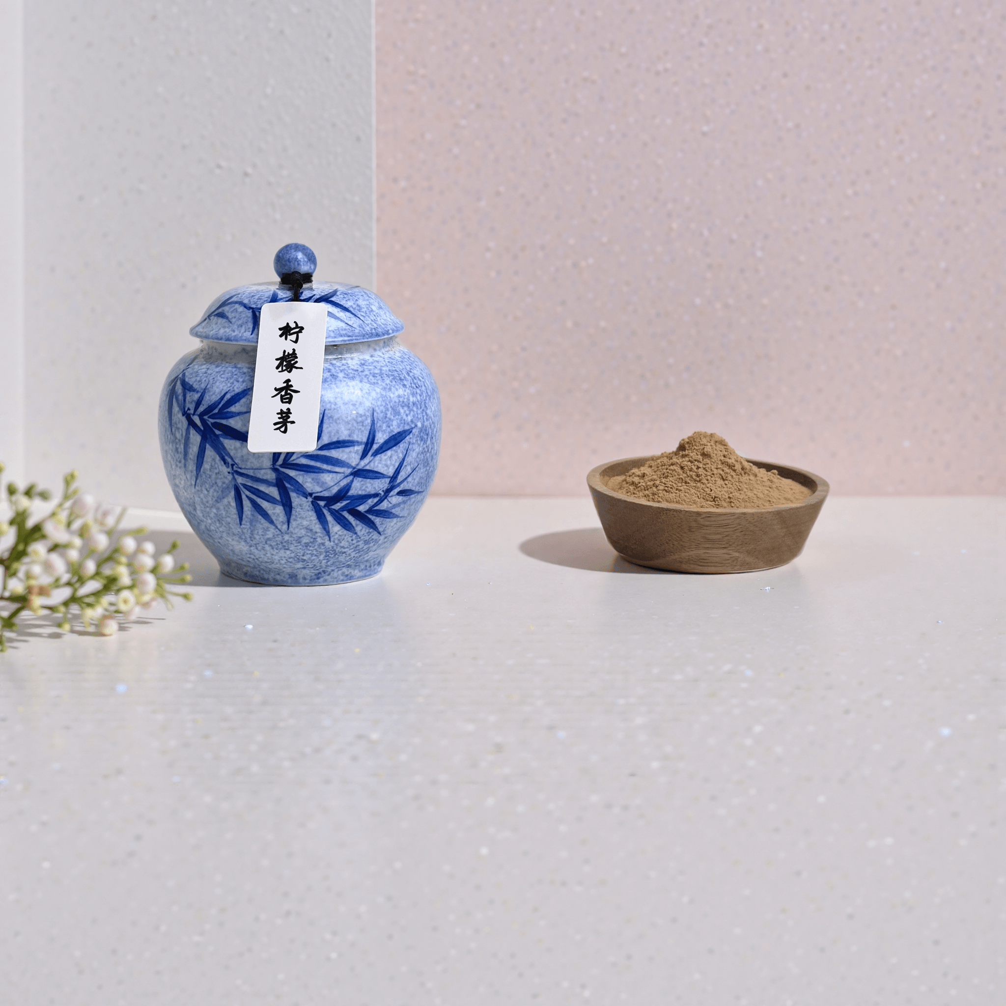 Lemongrass handcrafted natural incense powder in a blue ceramic jar, with some shown in a wooden bowl to display the powder.