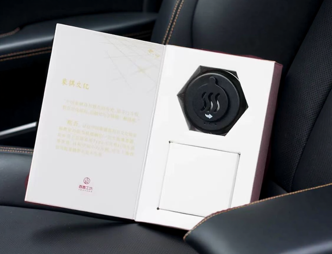 Portable electric car incense burner in gift box packaging, designed for aromatherapy heating with compact dashboard-friendly design