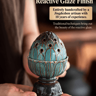 Hands holding a teal lotus ceramic incense burner, showing its reactive glaze, outlined petals and dark pedestal base.