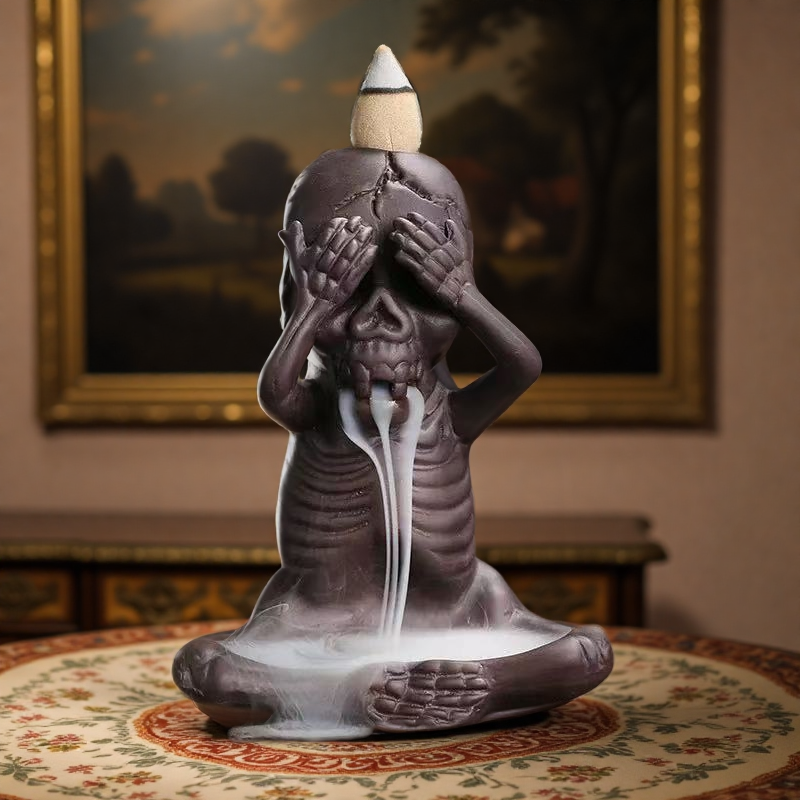 Single skeleton incense burner in "see no evil" pose with backflow smoke streaming downward.