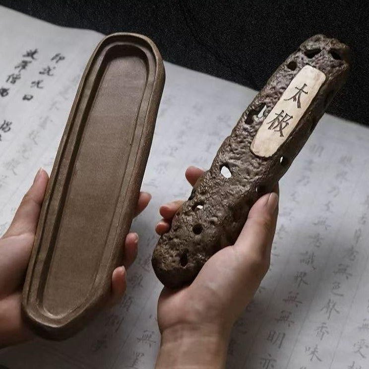 Hand holding open volcanic ceramic incense holder box with "太极" label, shown above traditional Chinese script