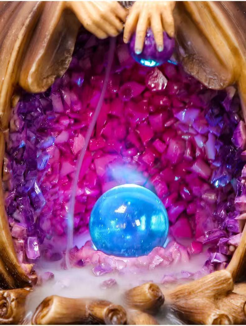 Close-up of wizard backflow incense burner showing glowing crystal ball and smoke