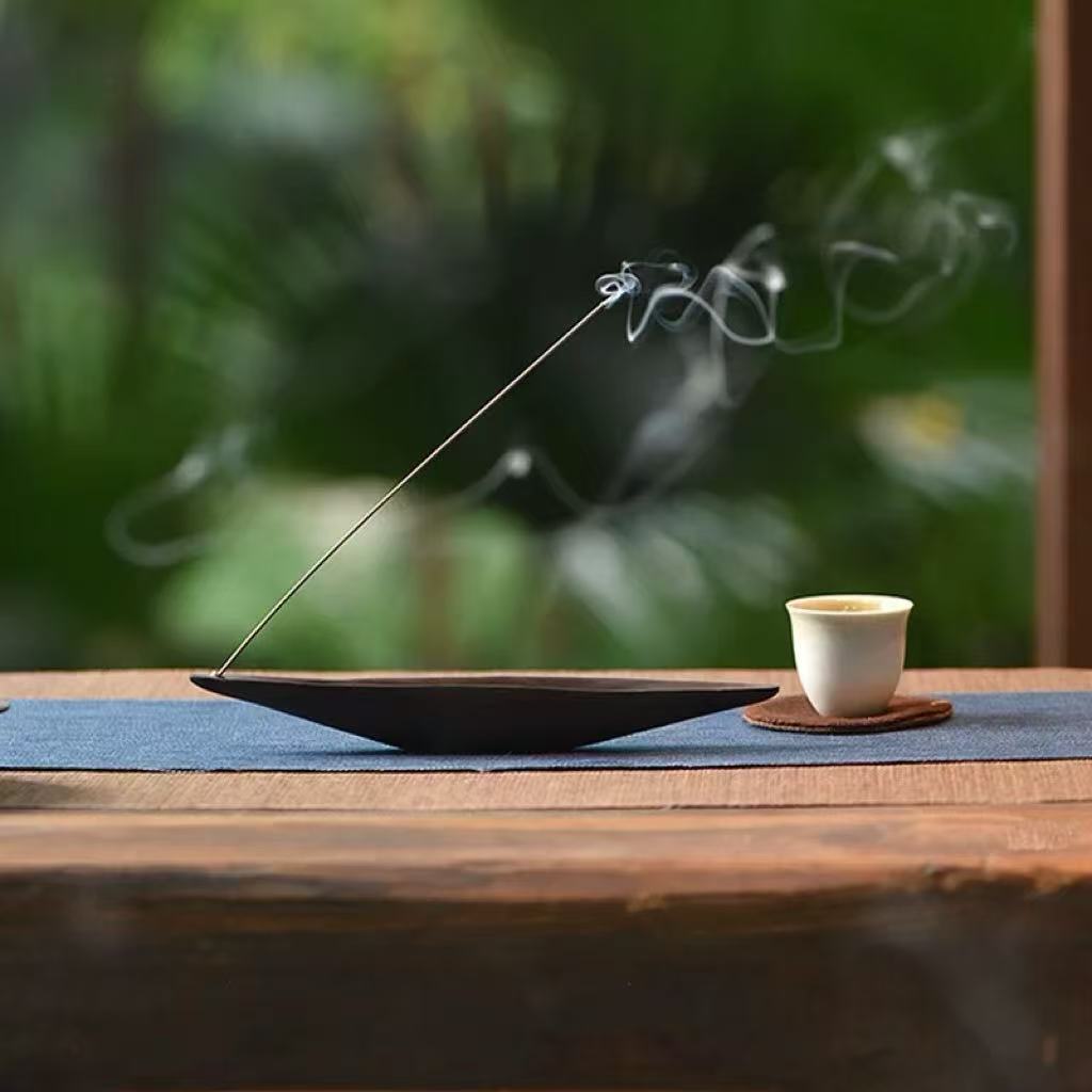 Wooden boat incense holder with smoke outdoor